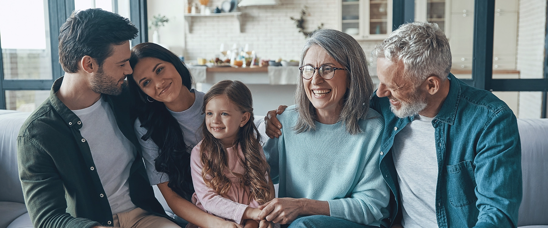 happy family spending time together smiling sitting on the sofa at home happy family spending time together smiling sitting on the sofa at home