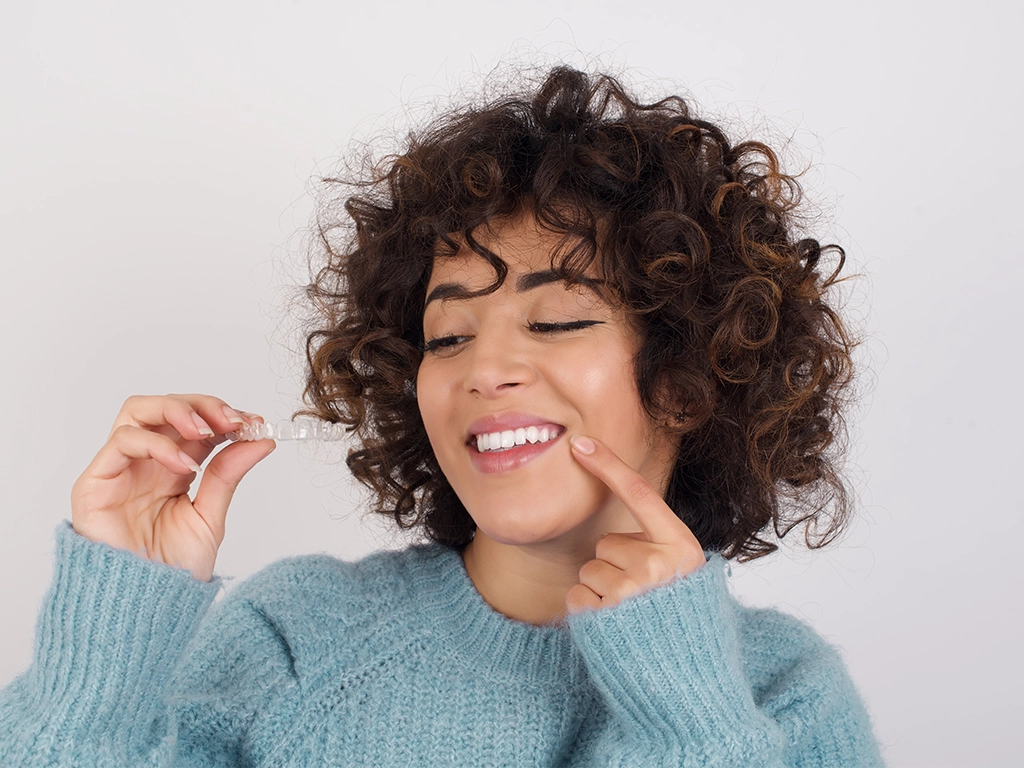 Beautiful girl smiling widely and showing her straight, healthy teeth